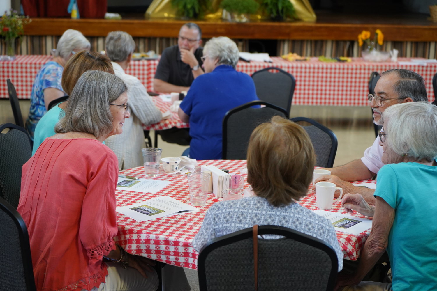 People take part in a "Eat and Learn" discussion about homelessness, in the Sacred Heart Parish Activity Building in Columbia.